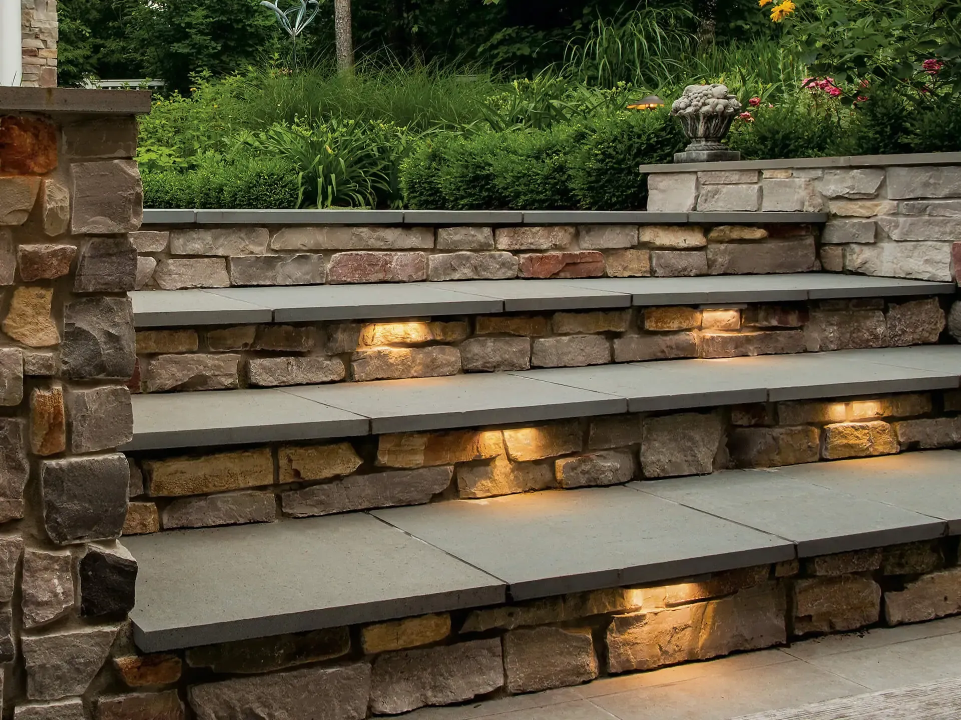 Trench dug in a grassy yard, leading to a house with black siding, and an electrical box.
