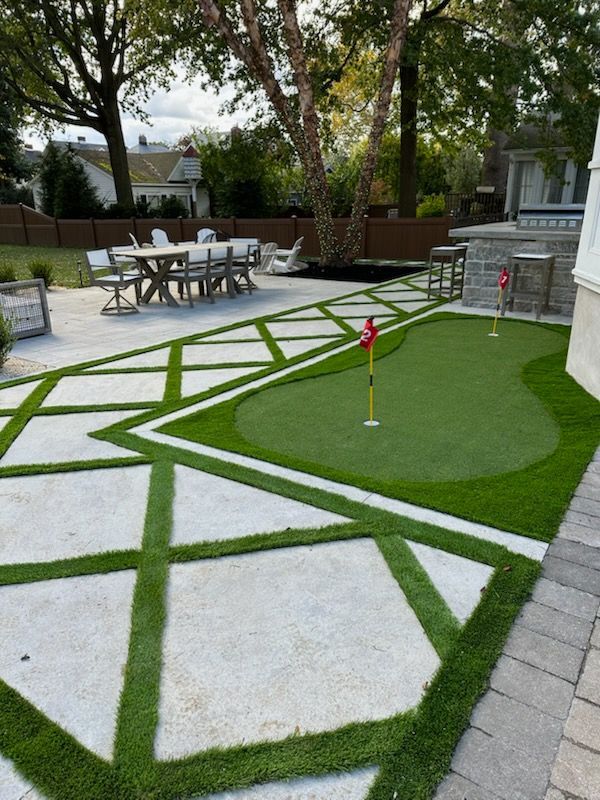 Brick house with new paved walkway leading to the front door. Grey and black paving stones.