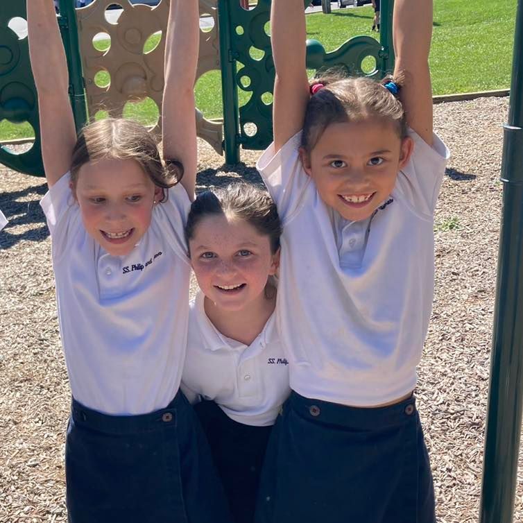 Three girls playing on the playground.