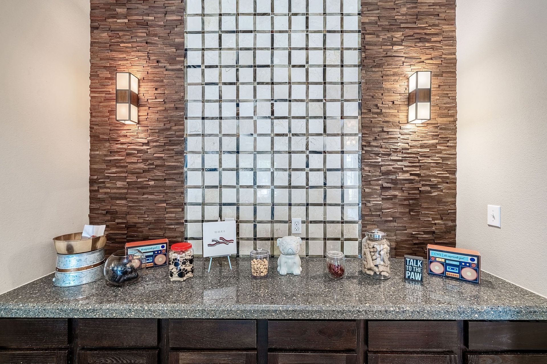a bar with a glass wall and a counter top with drinks and decorations