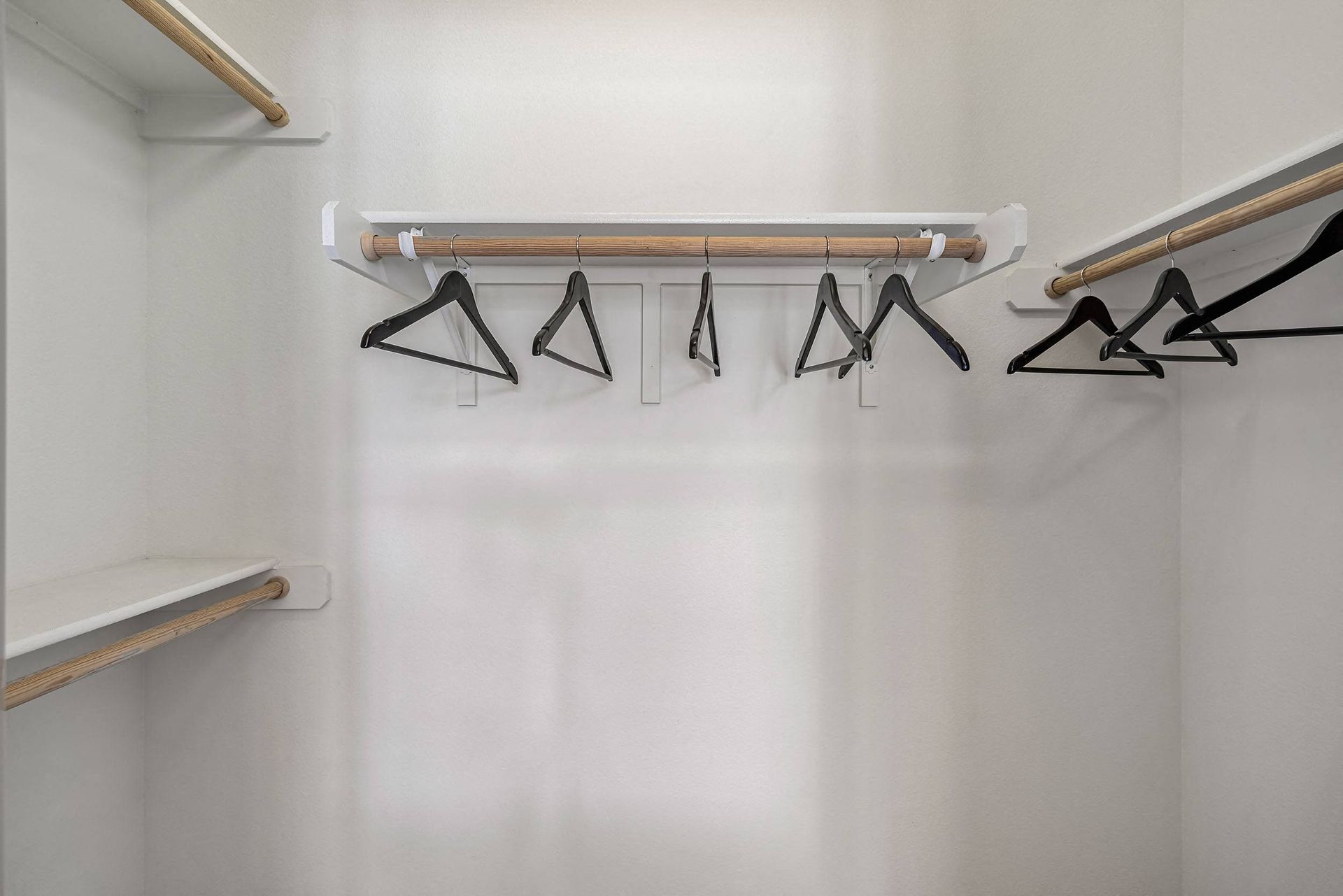 a rack with triangles hanging from a wall in a white room