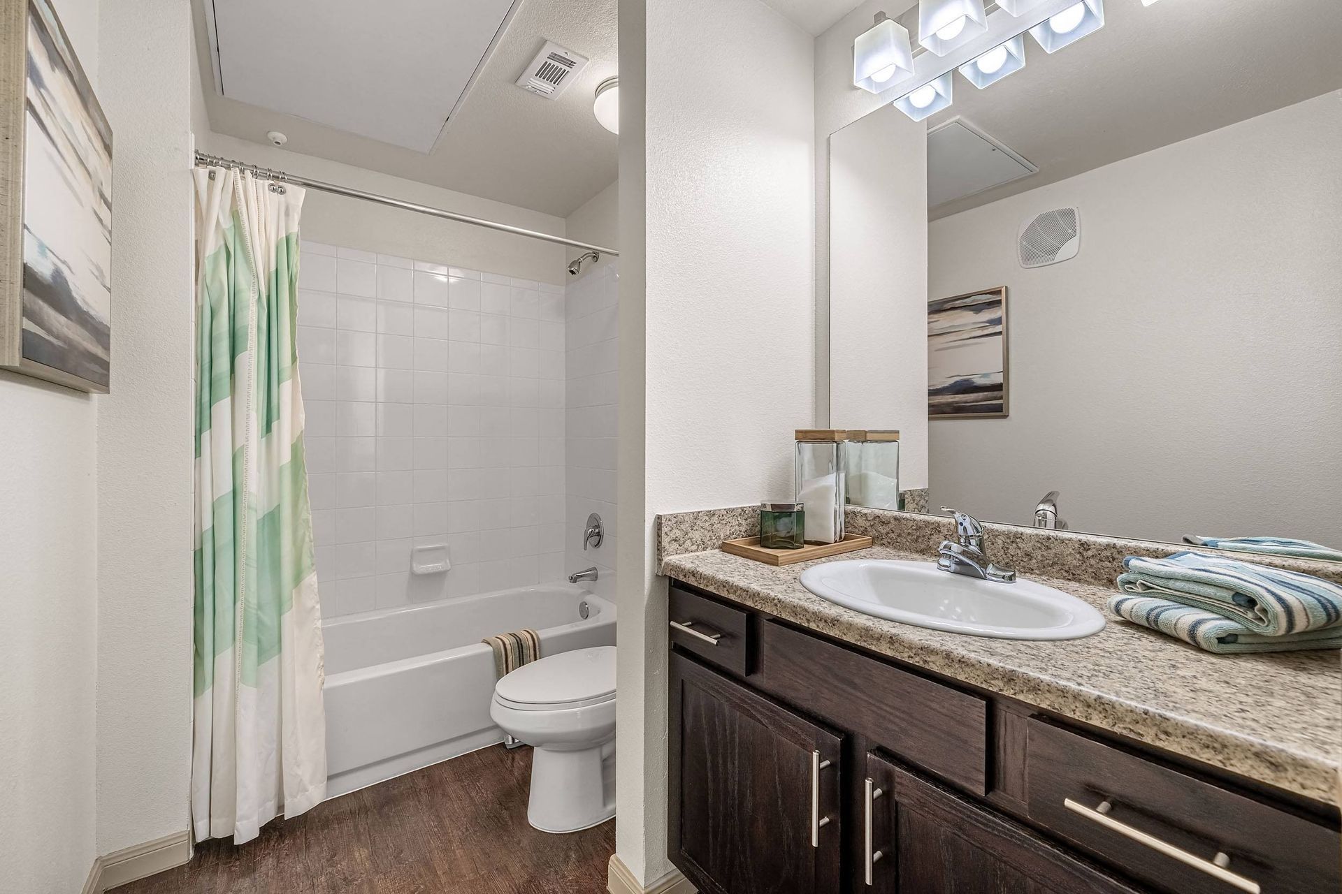a bathroom with a sink and a shower and a toilet