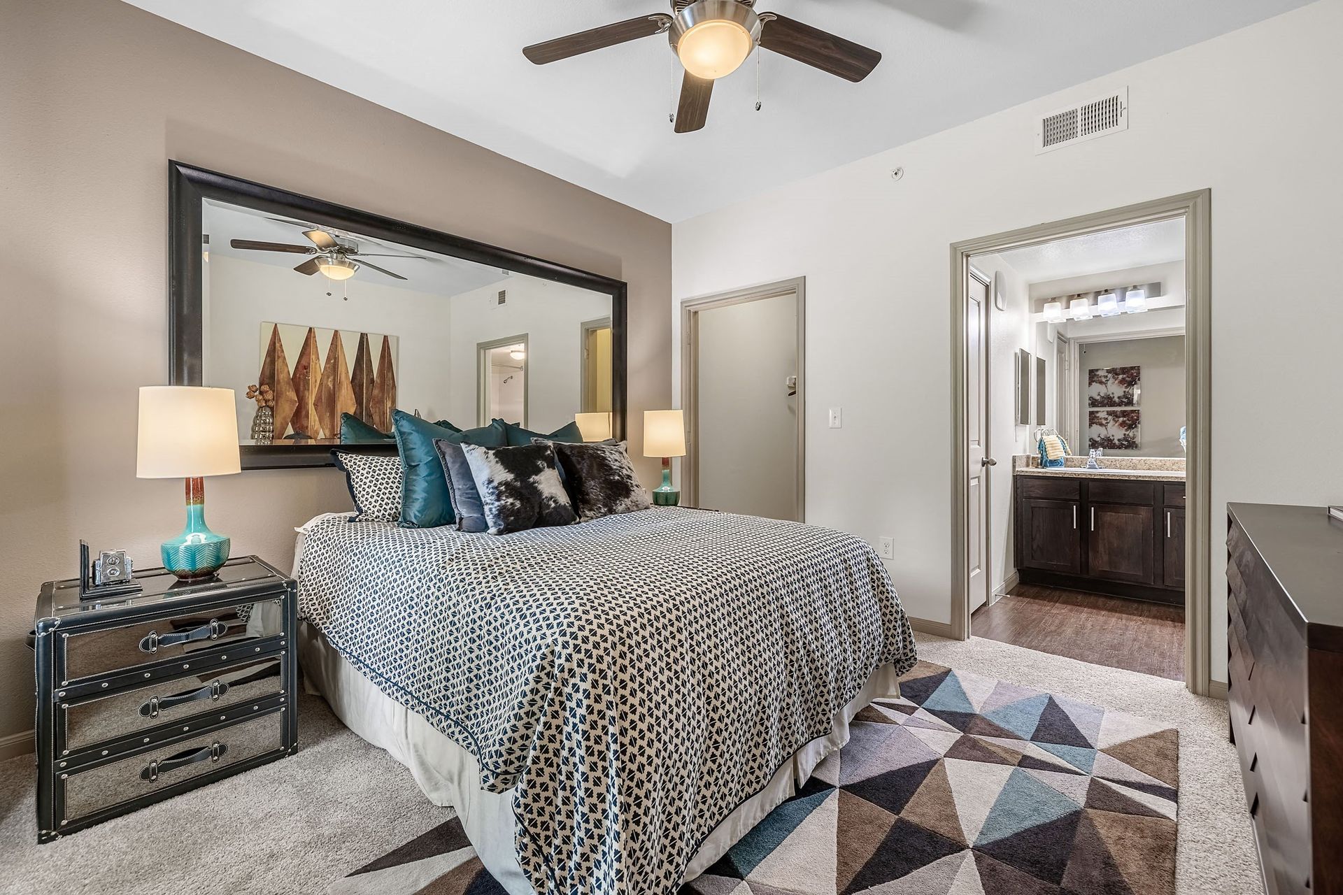 a bedroom with a bed and a ceiling fan