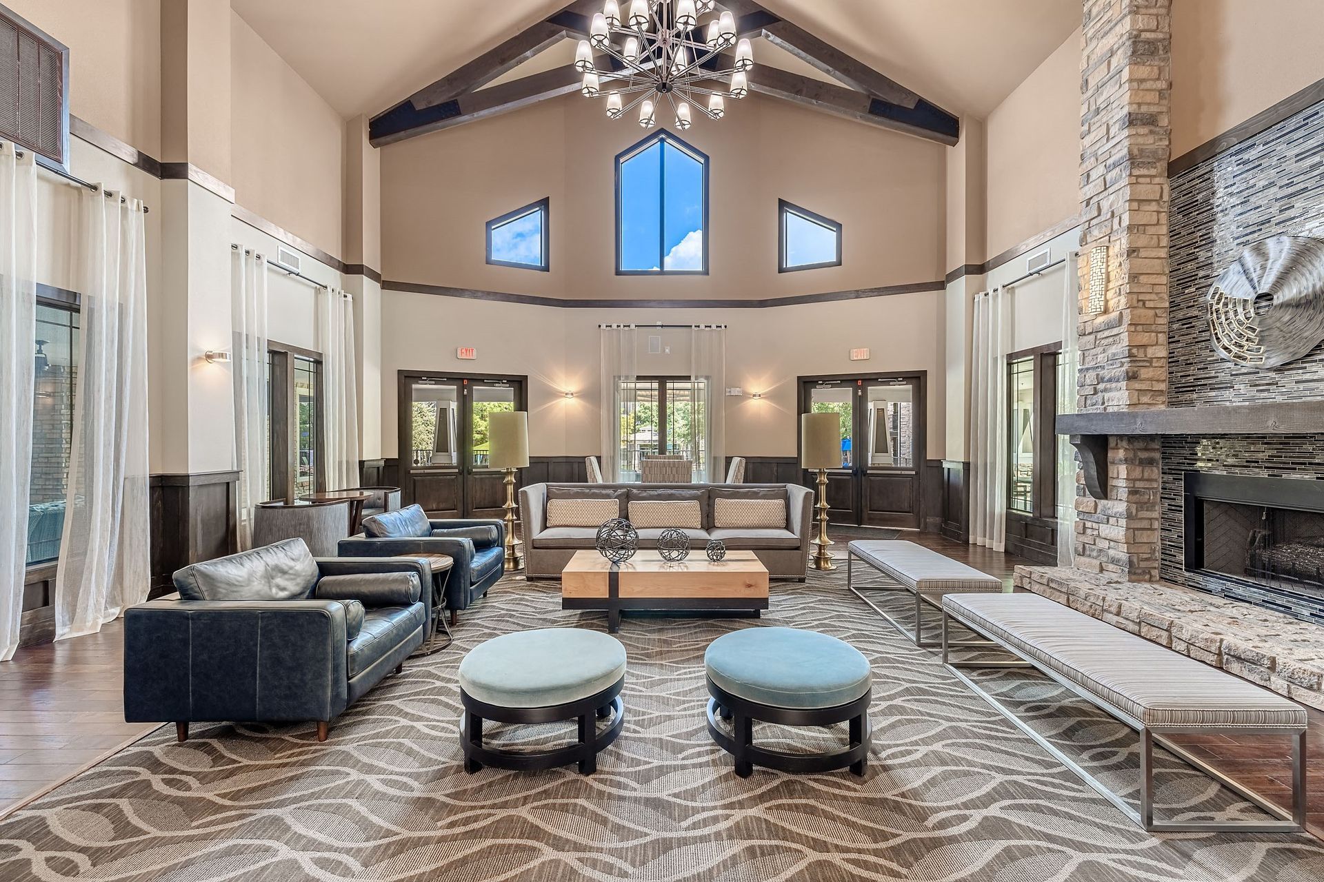 a large living room with couches and chairs and a fireplace