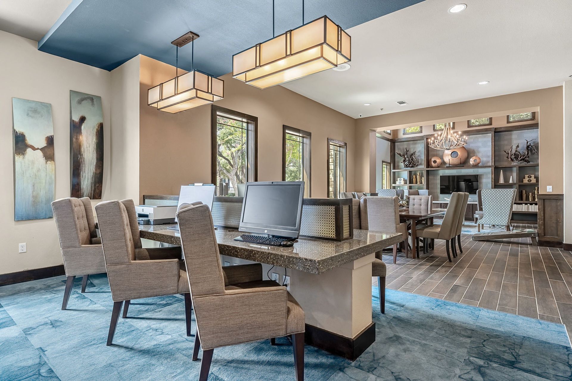 a large dining room with chairs and a table with a laptop