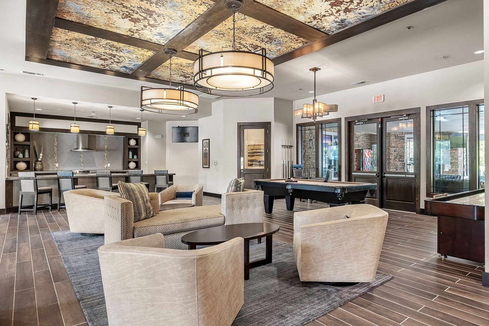 a clubhouse with a billiards table and couches