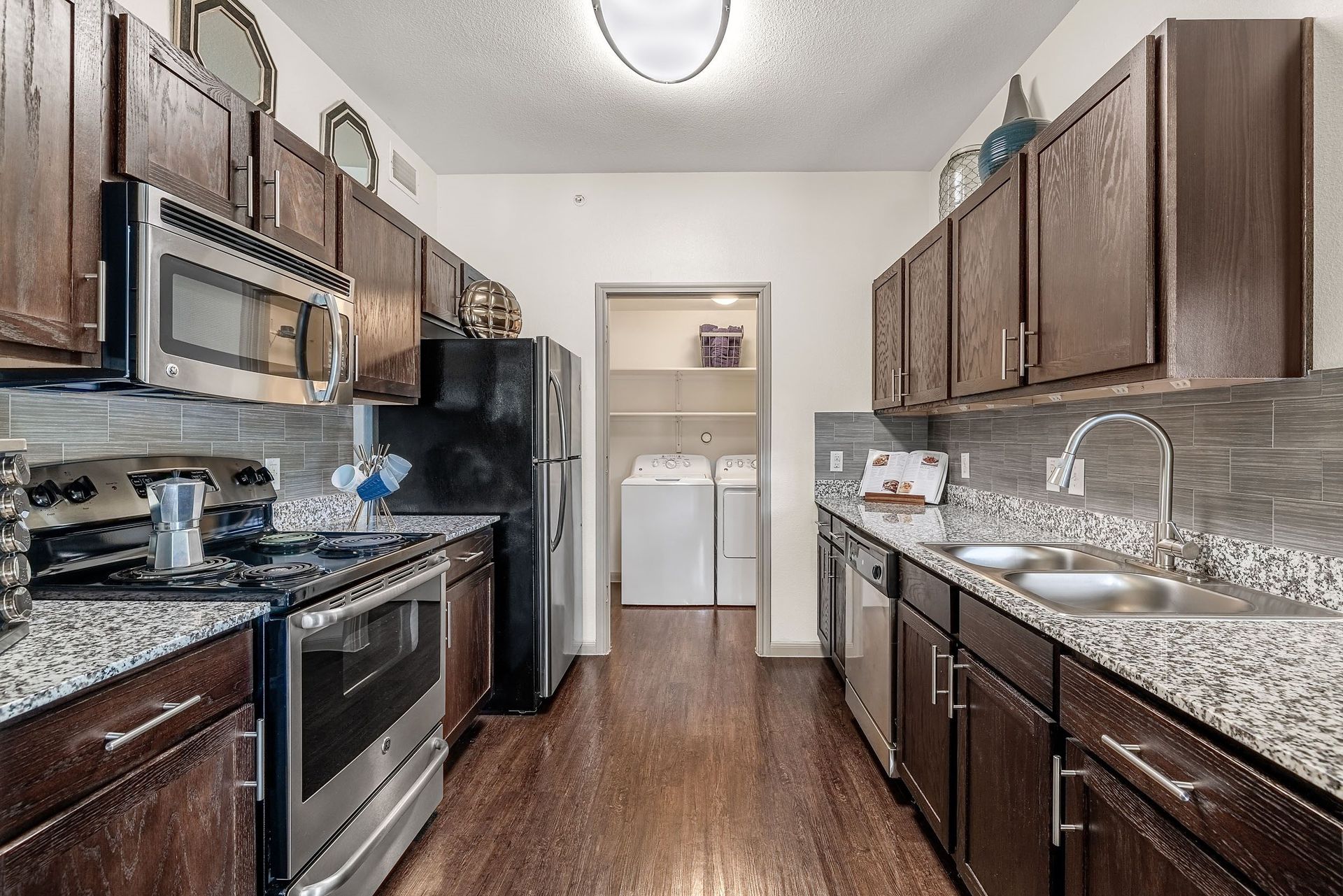 a kitchen with stainless steel appliances and granite counter tops