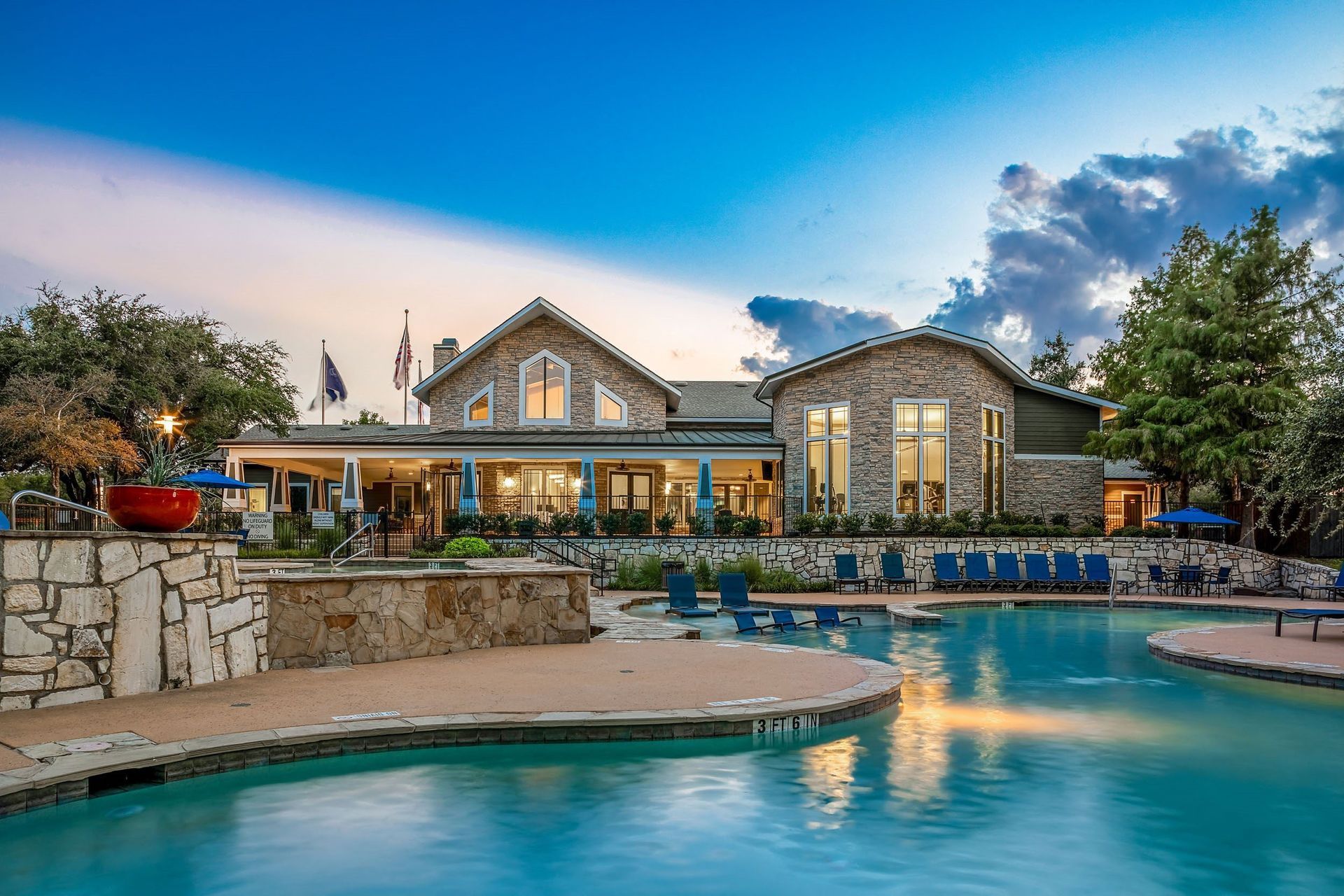 a swimming pool with a house in the background