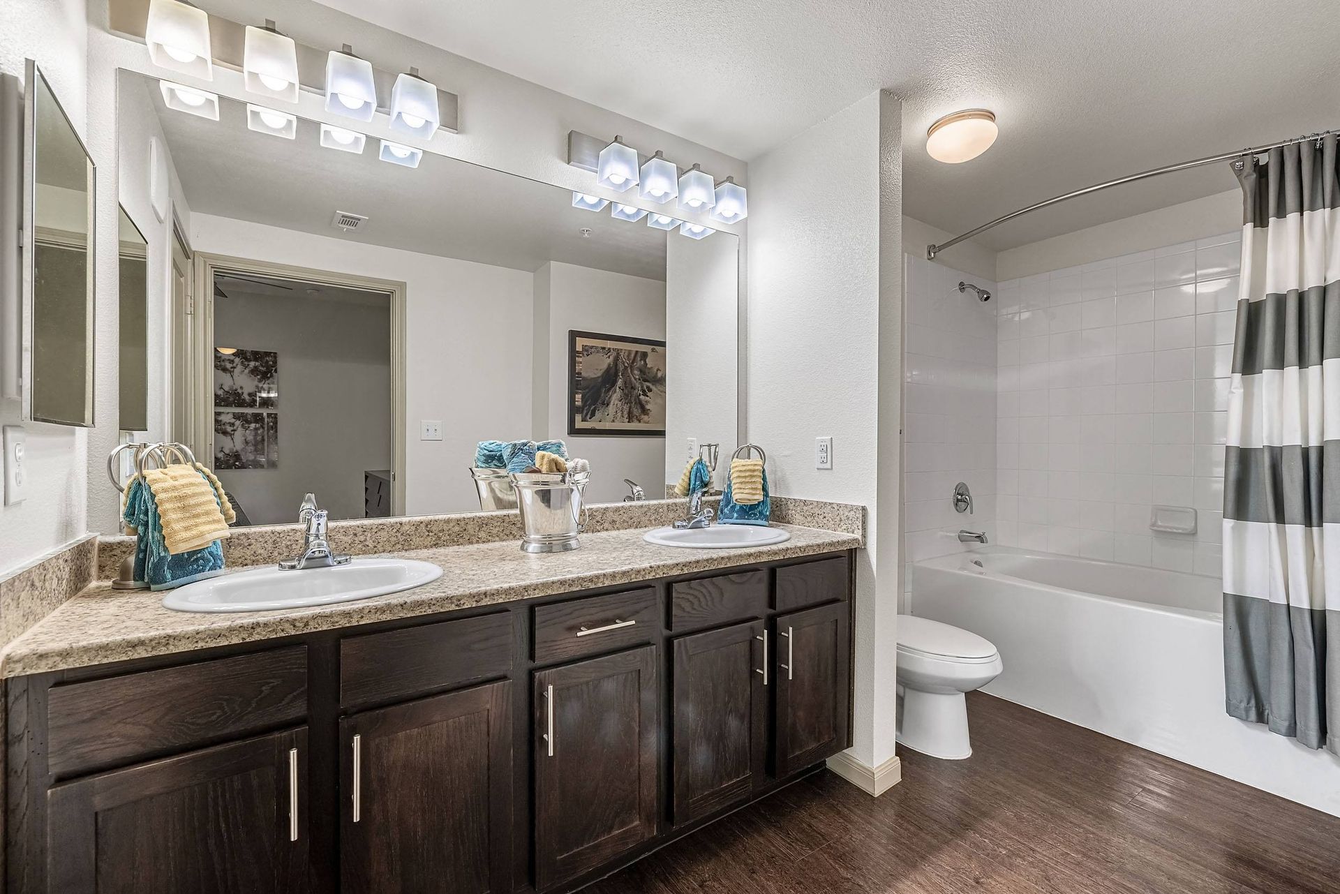 a bathroom with two sinks and a shower and a toilet