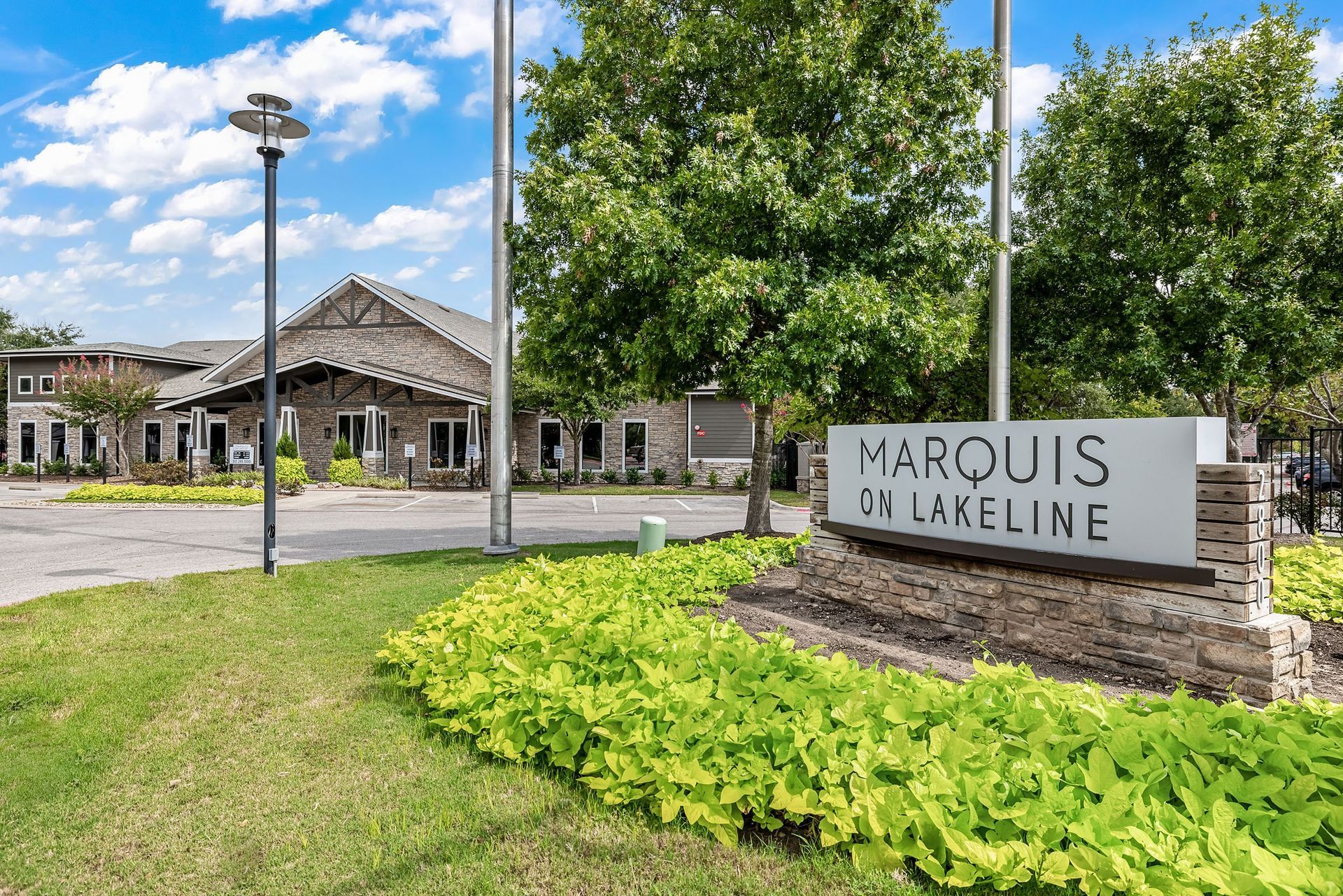 the entrance on lakeline with a sign in front of a building