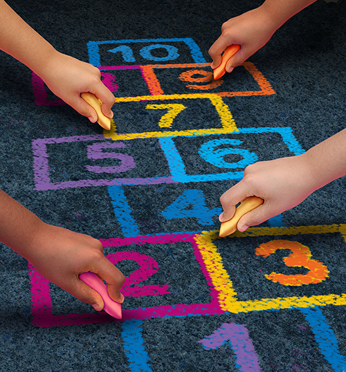 Children drawing a colorful hopscotch grid with chalk on asphalt.