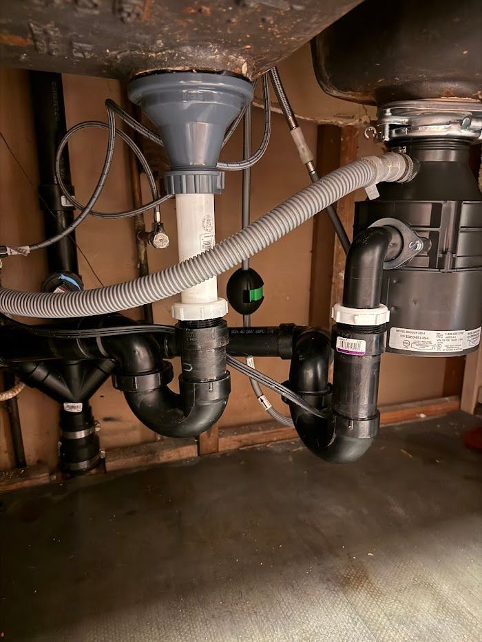 A kitchen sink with a garbage disposal underneath it.