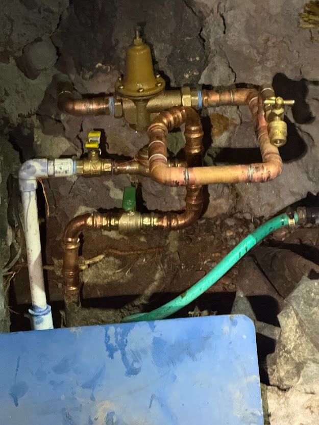 Copper pipes are connected to a valve and a hose