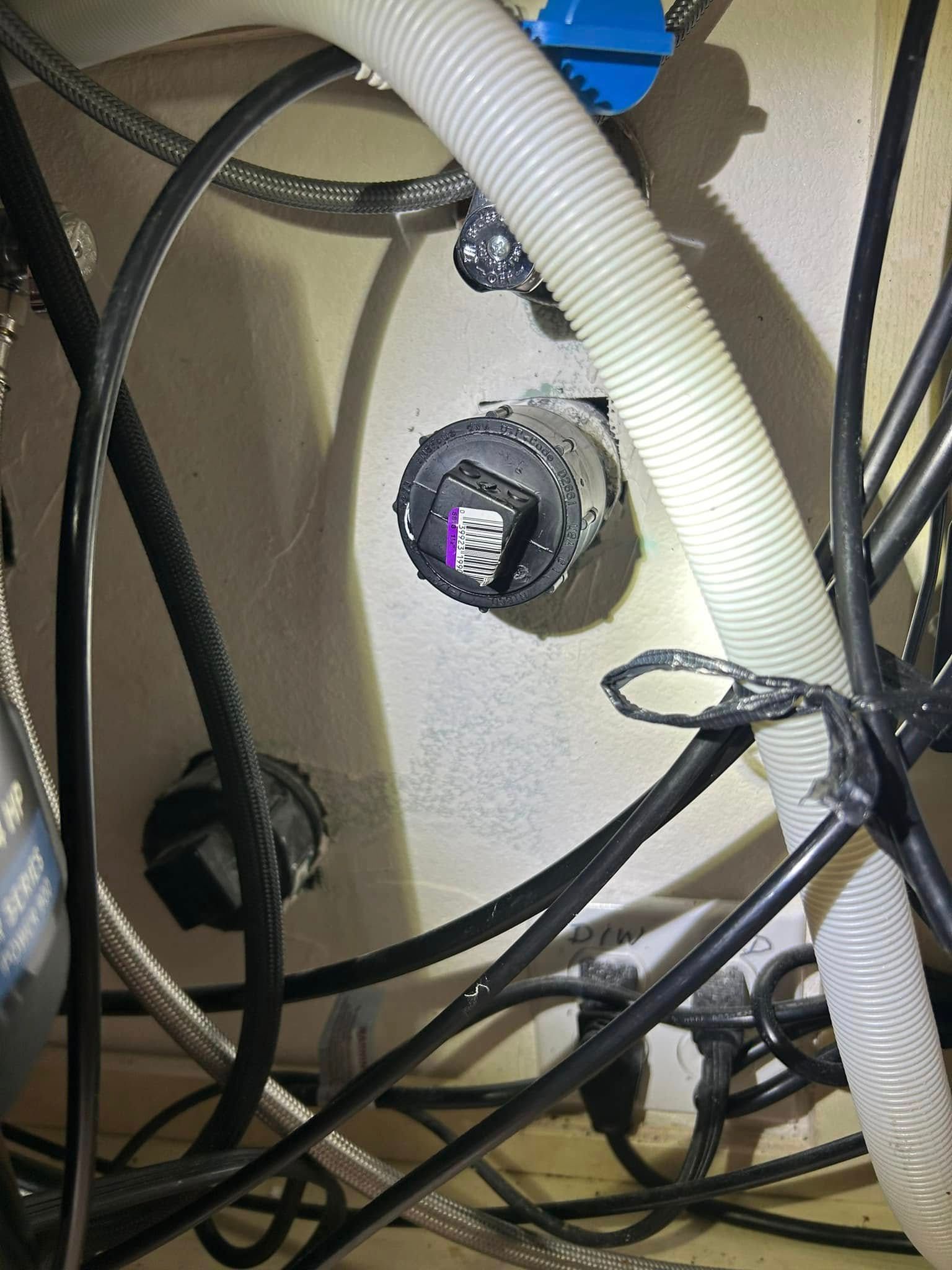 A bunch of wires are hanging from the ceiling of a room.