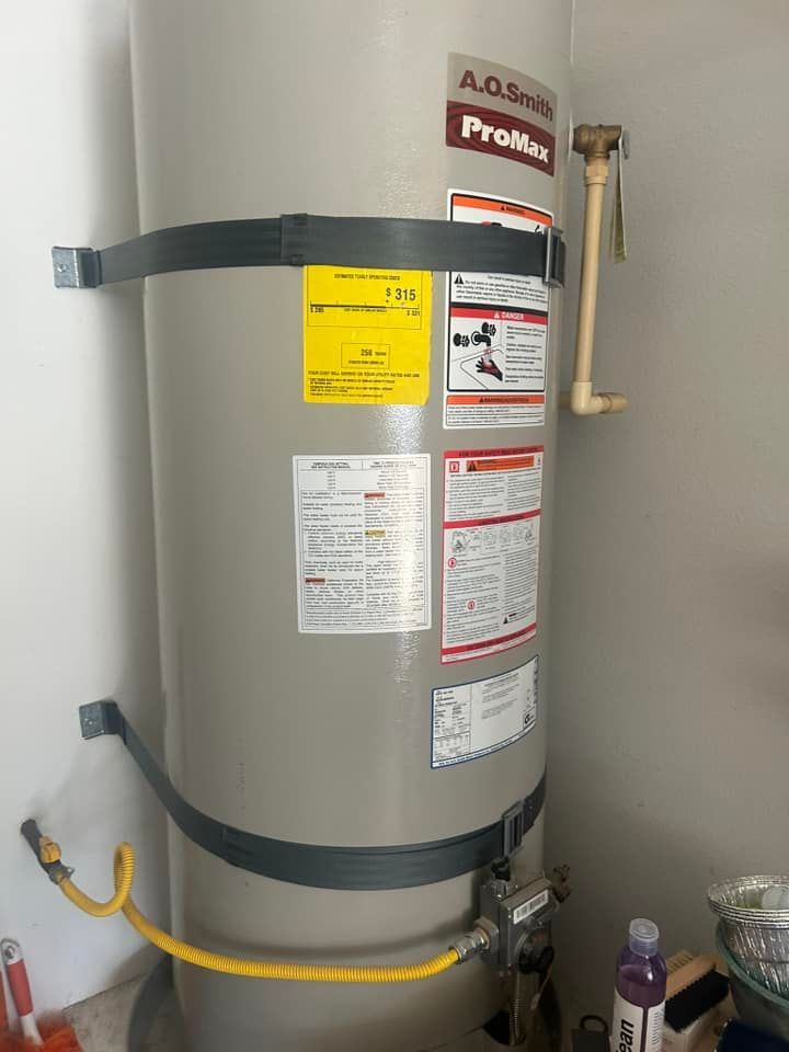 A water heater is sitting in a room next to a wall.