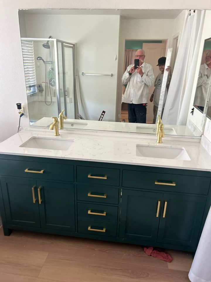 A man is taking a picture of himself in a bathroom mirror.