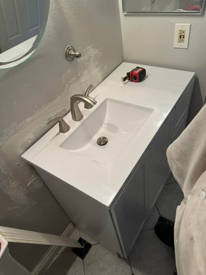 A bathroom sink with a measuring tape on top of it.