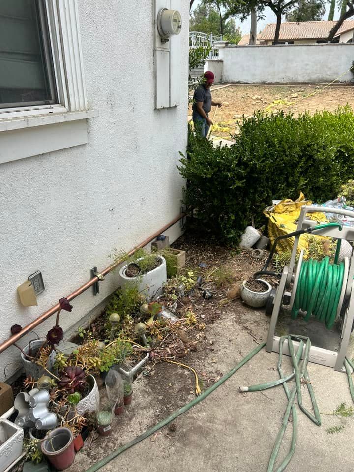 A man is working on the side of a house.