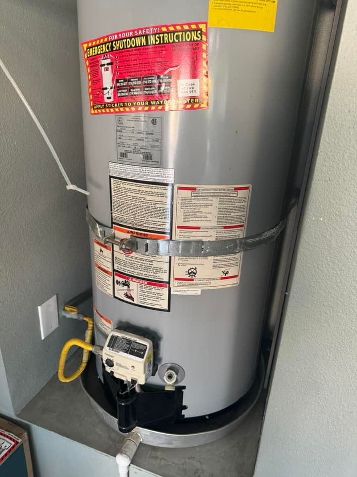 A water heater is sitting on a shelf in a room.