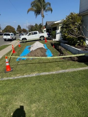 A white truck is parked in the grass in front of a house.