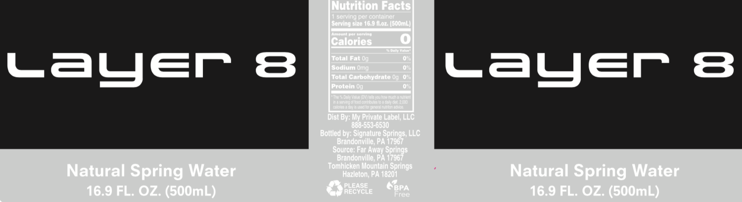 A bottle of natural spring water with a label that says layer 8