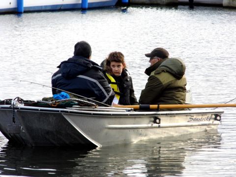 2 men and boy in fishing boat on River Bure, Wroxham