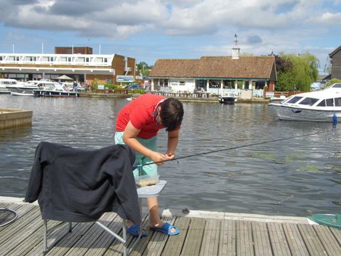 young boy tackling up by river bank on River Bure, Wroxham