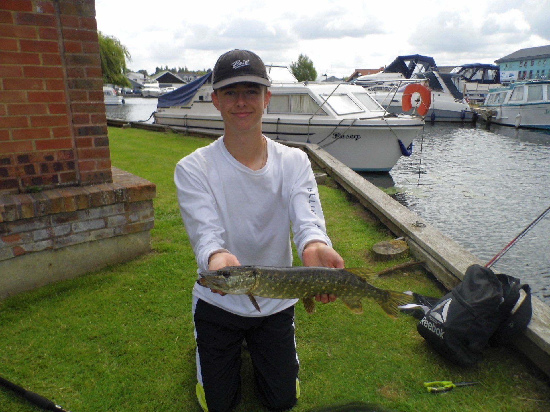 Teen showing camera his proud catch to the camera
