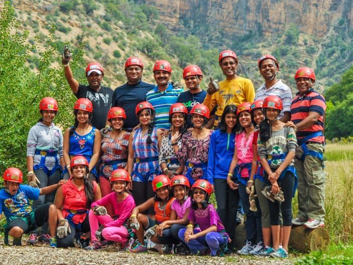 A group of people wearing helmets are posing for a picture.