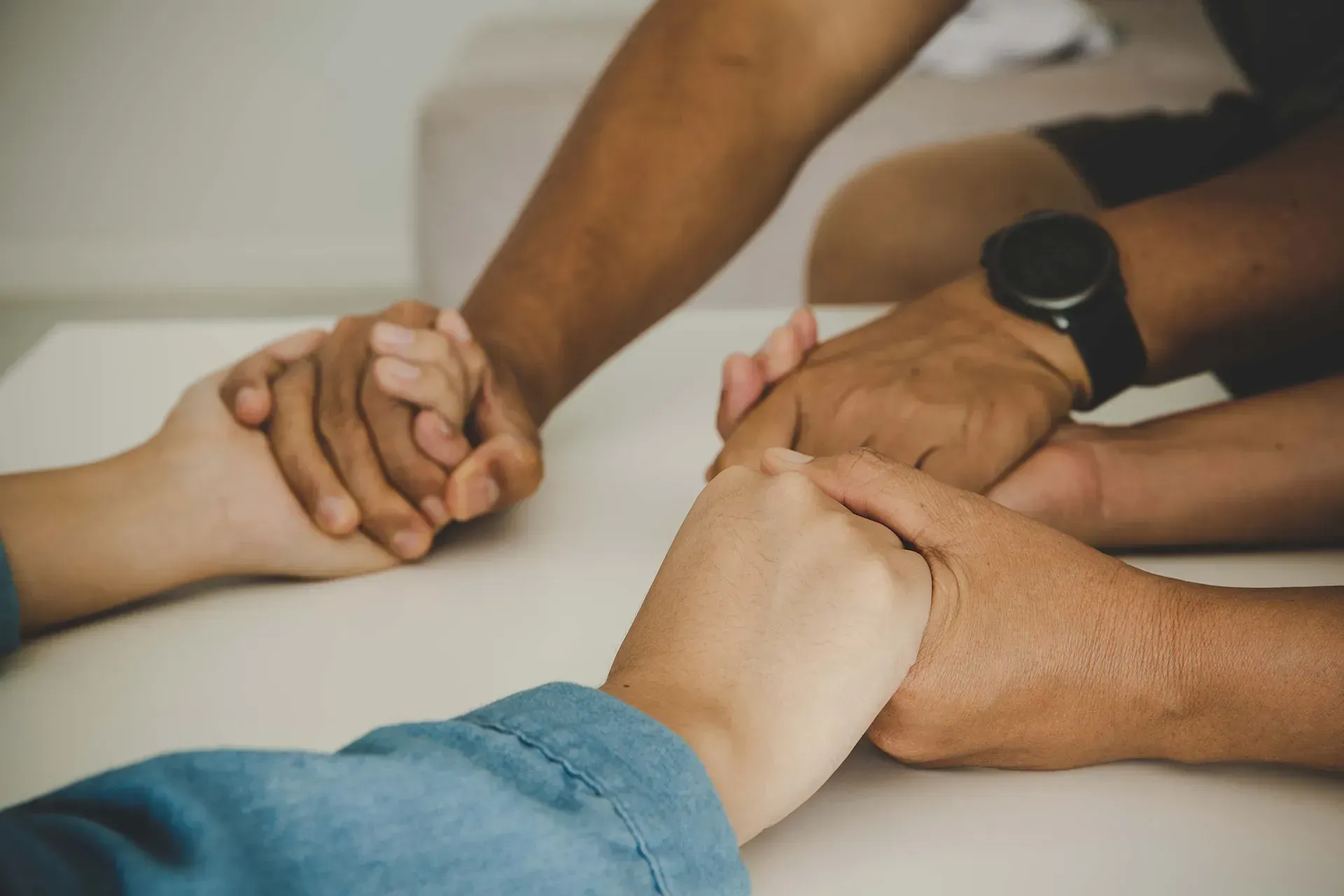 Family holding hands during loss of loved on in Plantation, Sunrise FL