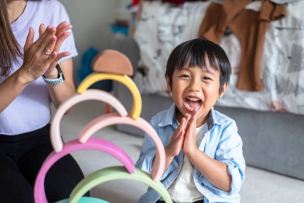 Happy toddler boy playing in his kindergarten class.