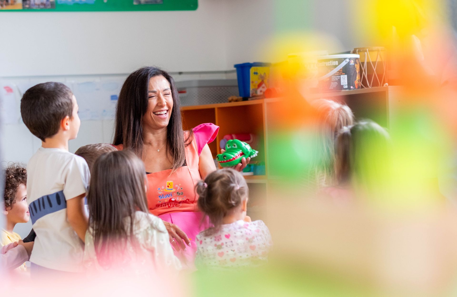 Children playing with their teacher. Children playing with their teacher.