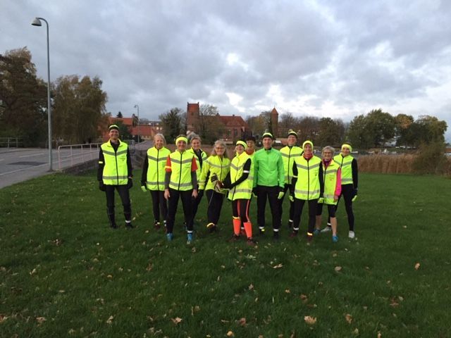 En gruppe mennesker poserer til et billede på en mark