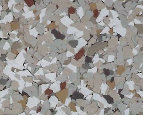Close-up of a speckled floor. White, tan, brown, and red chips are embedded in a light gray base.
