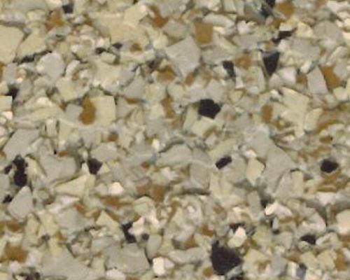 Close-up of recycled foam, primarily tan, with some black and white pieces.