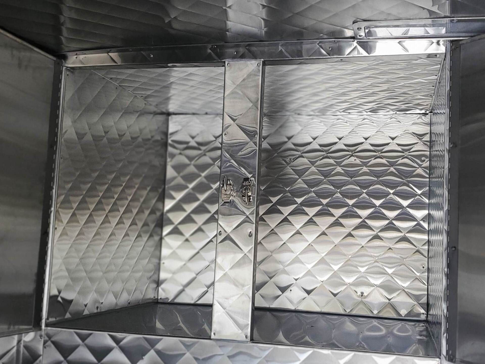 A stainless steel cabinet with a diamond pattern on it
