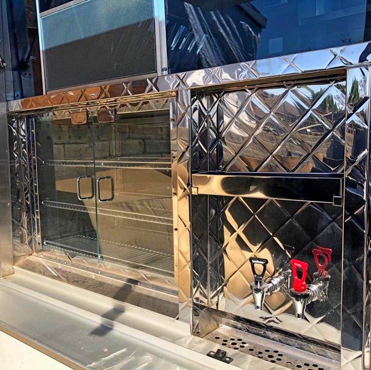 A stainless steel cabinet with a reflection of a building in it