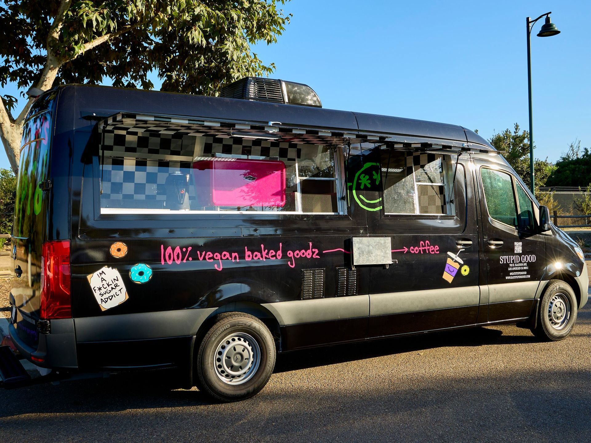 A colorful juice truck is parked in SD Food Truck Pros parking lot.