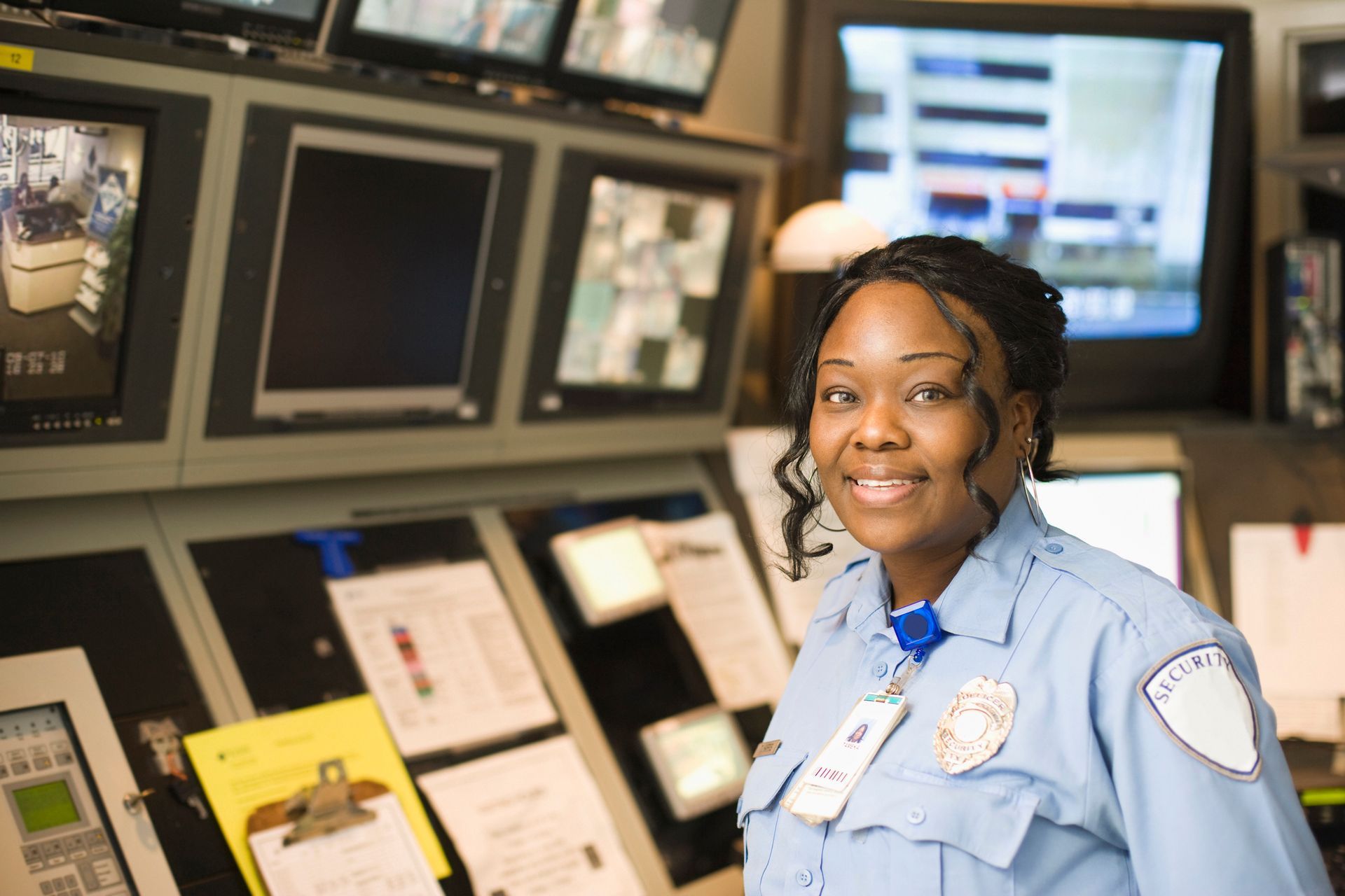 A group of men in yellow vests are standing on a soccer field.
