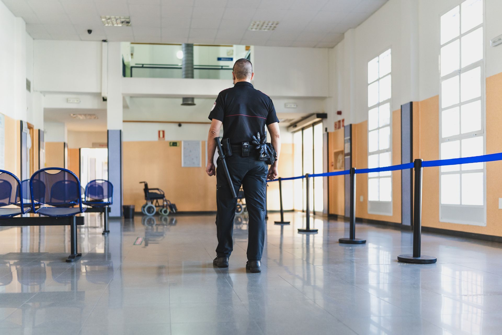 A security officer with his back turned at the hospital.