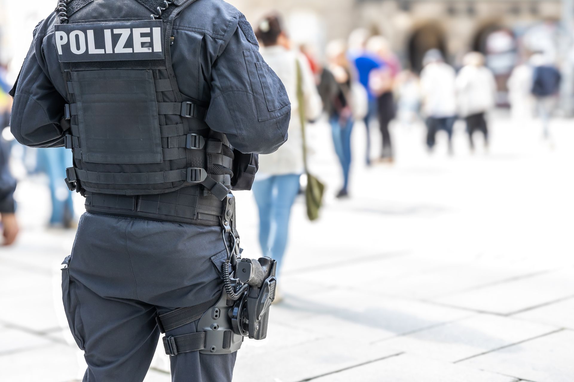 A close-up of a security guard man in a public area standing secure, protecting a place outdoors