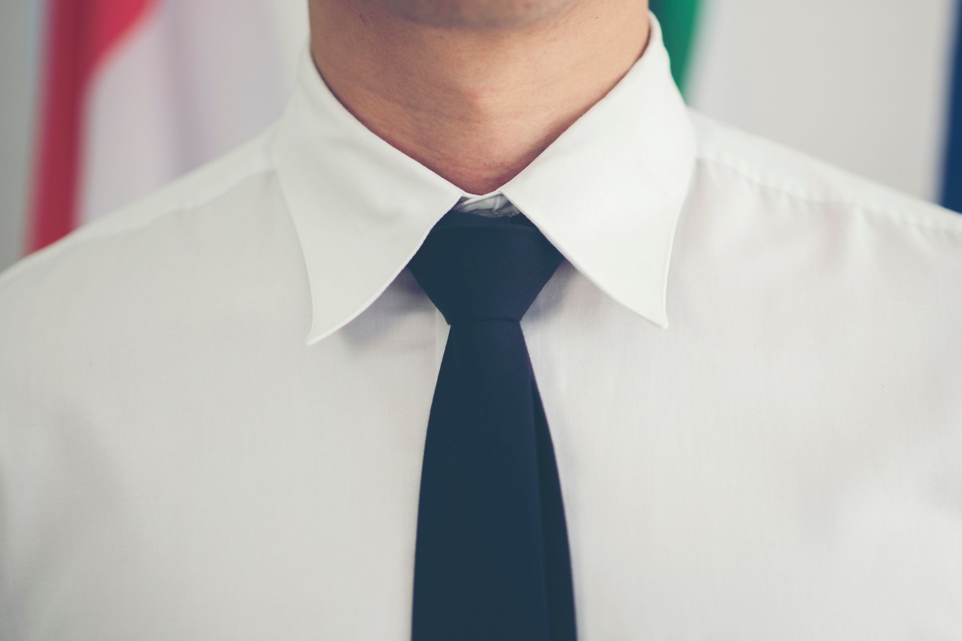 A man wearing a white shirt and a black tie