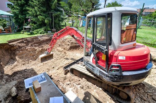 A Red And White Excavator Is Digging A Hole In The Ground - Micro Excavations & Earthmoving in Burleigh Heads, QLD