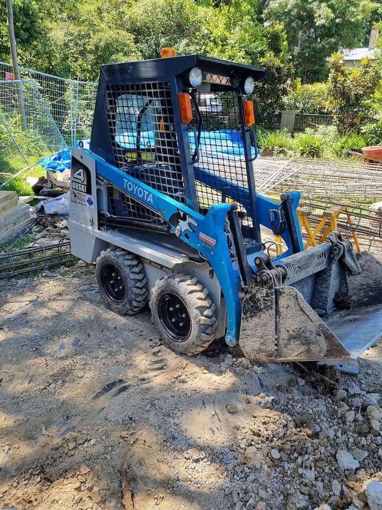 A Skid Steer Is Parked On A Dirt Road - Book a Micro Bobcat on the Gold Coast, QLD