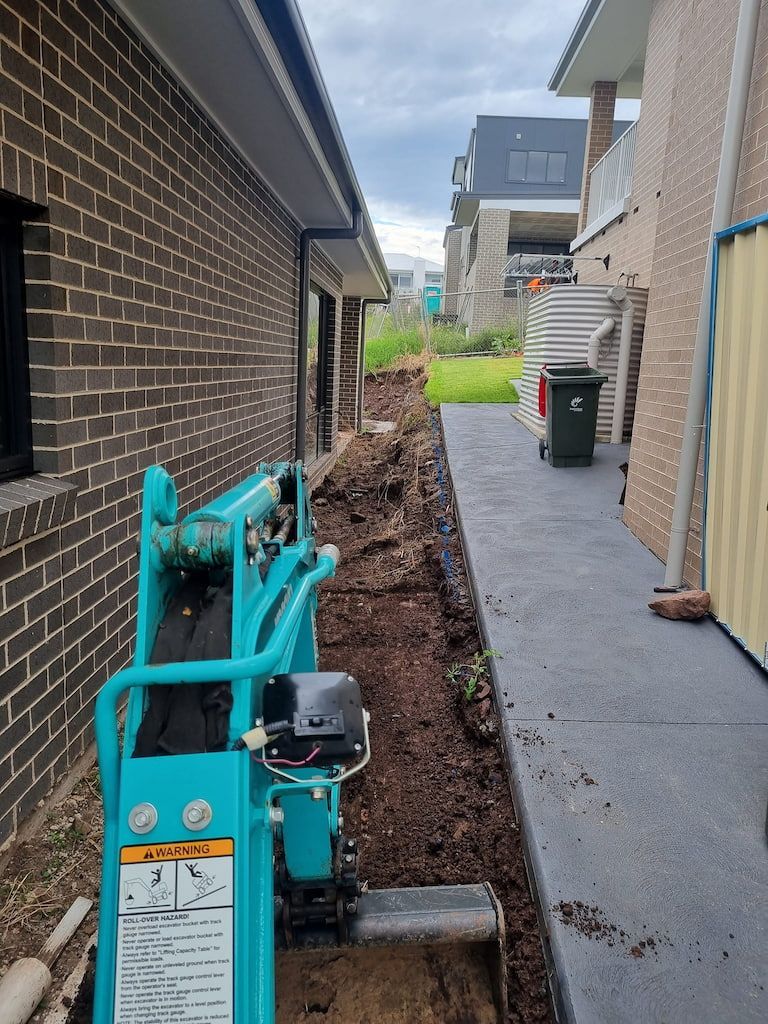 A Warning Sign Is On The Side Of A Machine - Mini Earth Works & Excavation on the Gold Coast, QLD