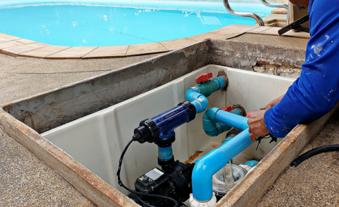 Picture of man working on underground pool line.