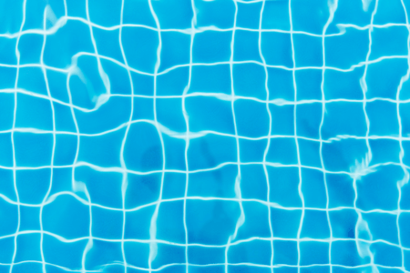Picture of blue pool tiles underwater.