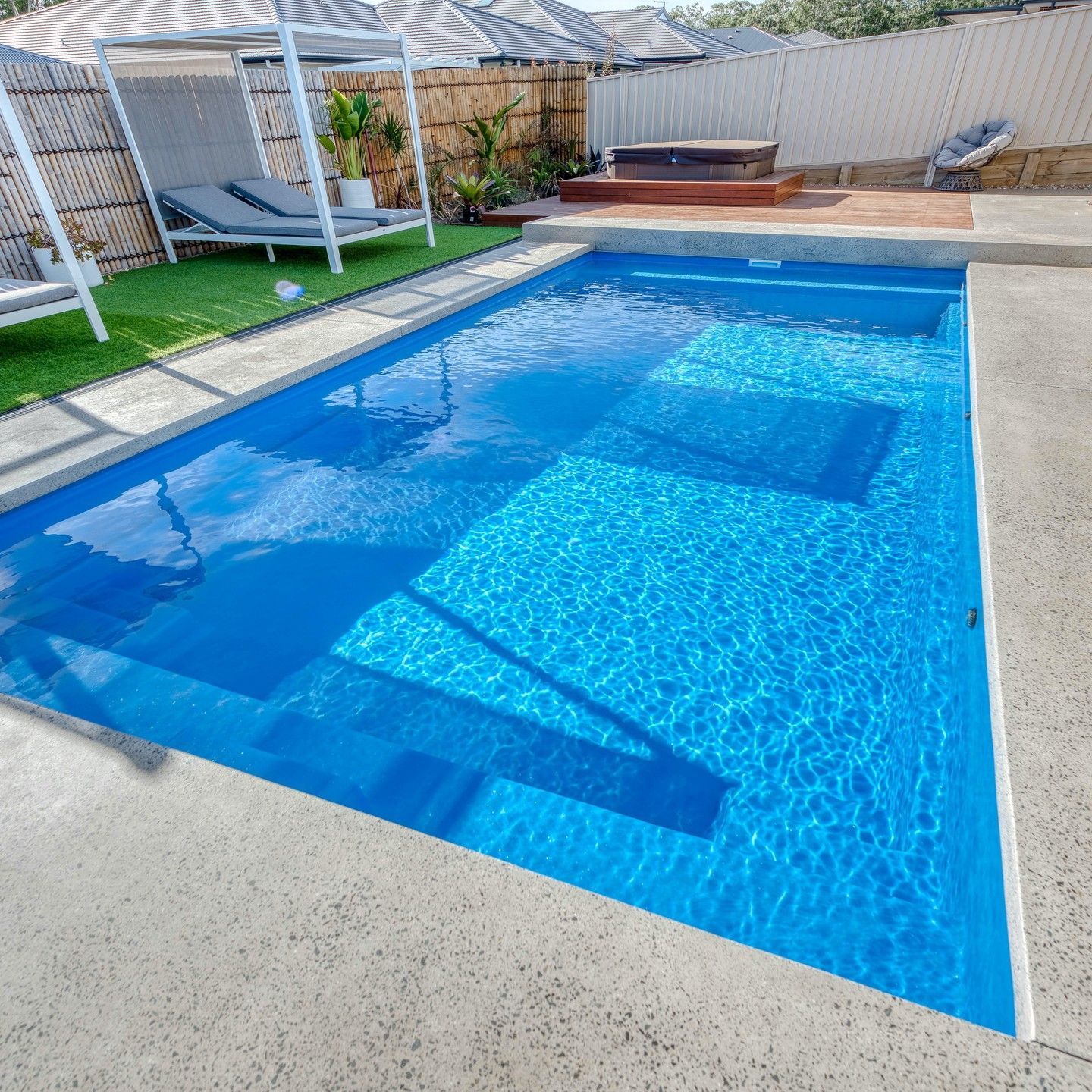 Blue Rectangular Swimming Pool With Steps, Concrete Patio, and Seating Area — Bombs Away Pools in Coolangatta, QLD