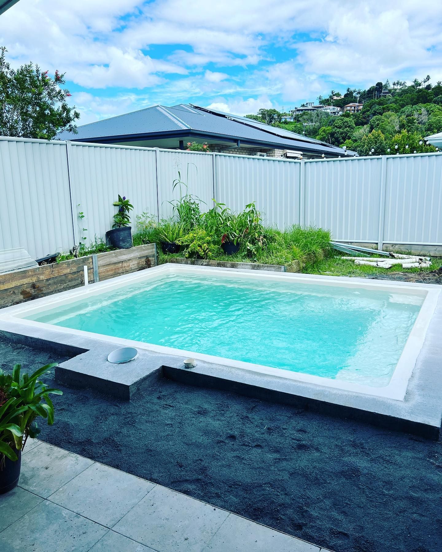 Rectangular Turquoise Pool Surrounded by Concrete, a White Fence — Bombs Away Pools in Coolangatta, QLD