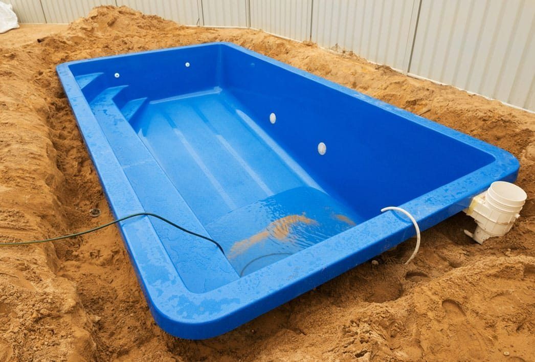 Blue Rectangular Prefabricated Pool in a Sand-filled Excavation, Ready for Installation — Bombs Away Pools in Robina, QLD